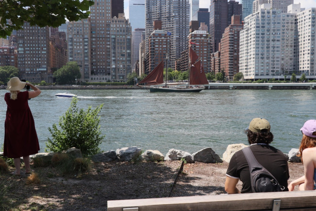 Spectators watching the tall ship parade on the East River in New York