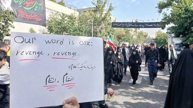 Tehran citizens displaying 'revenge' signs at the funeral of Ayatollah Khamenei