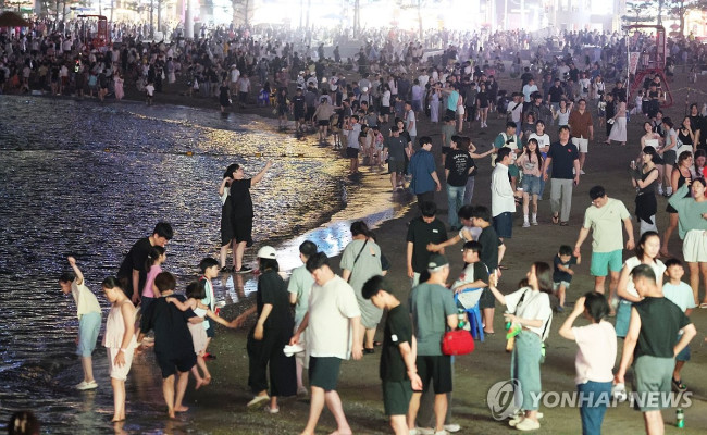 Vacationers enjoying a drone show and cooling off