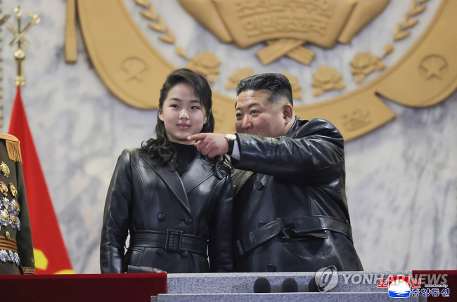 Kim Jong Un attends a military parade commemorating the Party Congress with his daughter Ju Ae